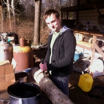 Gus inoculating logs with shiitake mushroom spawn.